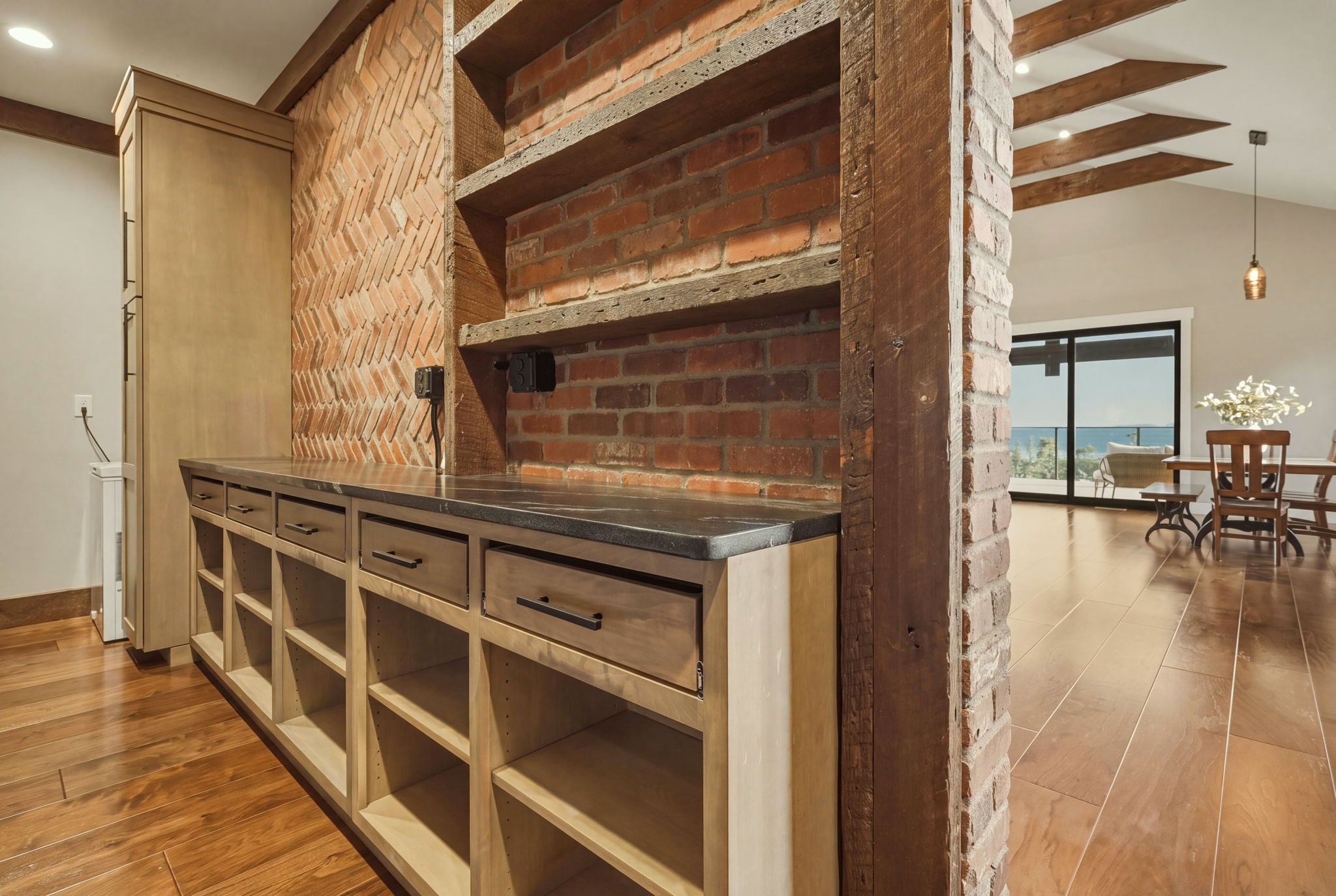 Open shelving and dining area with valley view through the windows behind