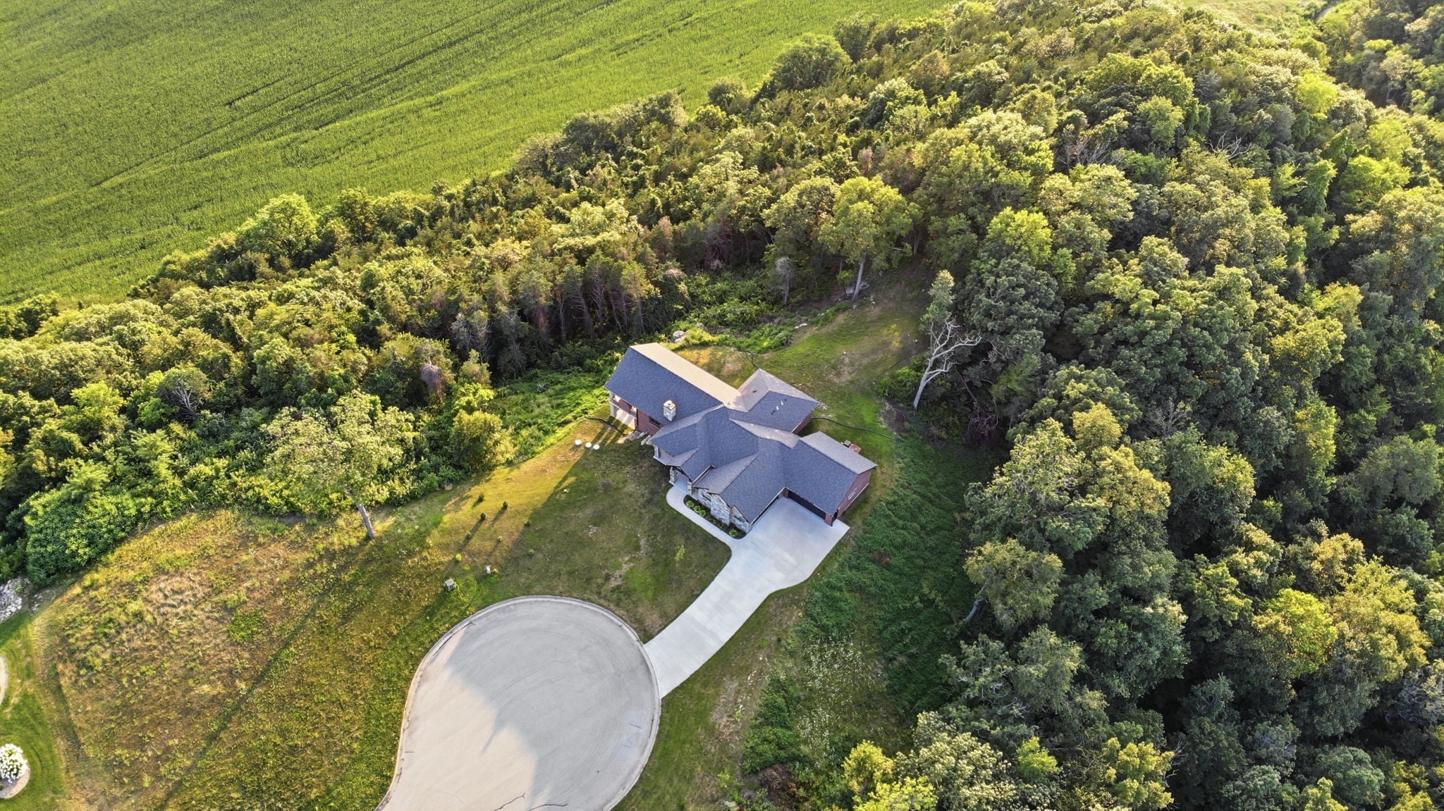 Aerial view of the house and wooded 2.51-acre lot