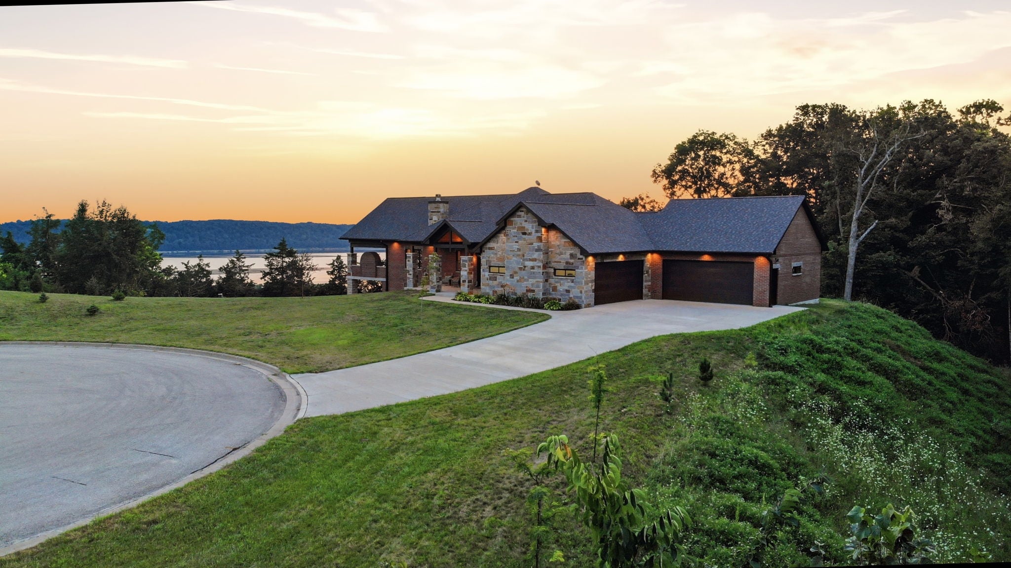 Aerial view at dusk of the house on the bluff above the river valley